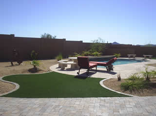 Pavers and artificial grass with pool
